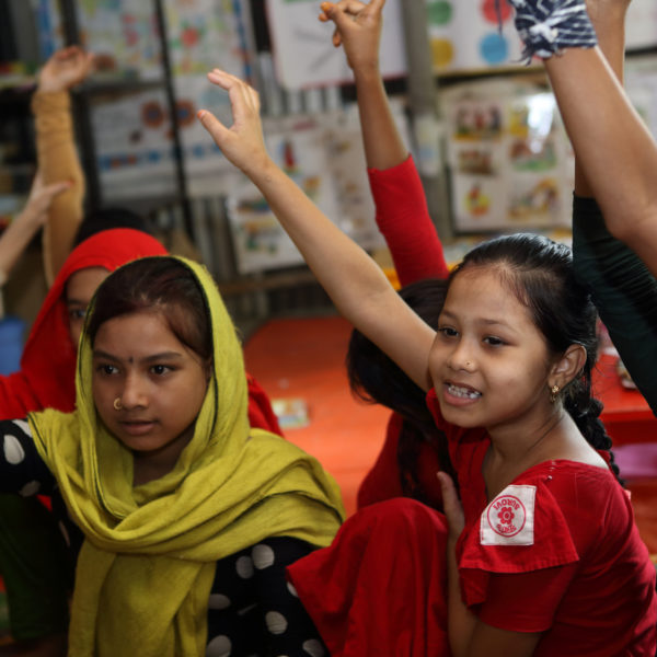 Children raise their hands at a Unicef-supported school in Bangladesh. Photo: Unicef 2016 Kiron