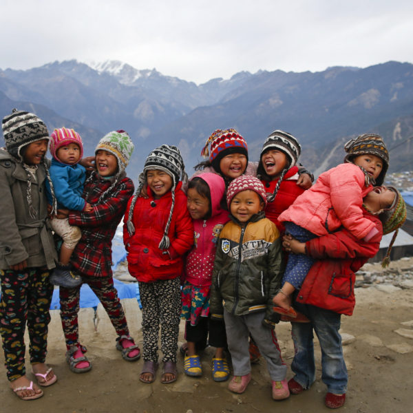 On 18 January 2016, children laugh in Barpak village, Gorkha district, Nepal. Barpak is an epicenteral village of Gorkha district, where more than 1400 hundreds houses were destroyed during the earthquake on 25 April 2015. Hundreds of earthquake victims, particularly the elderly and young children living in shelter of highland altitude have been facing a harsh winter season after snowfall.