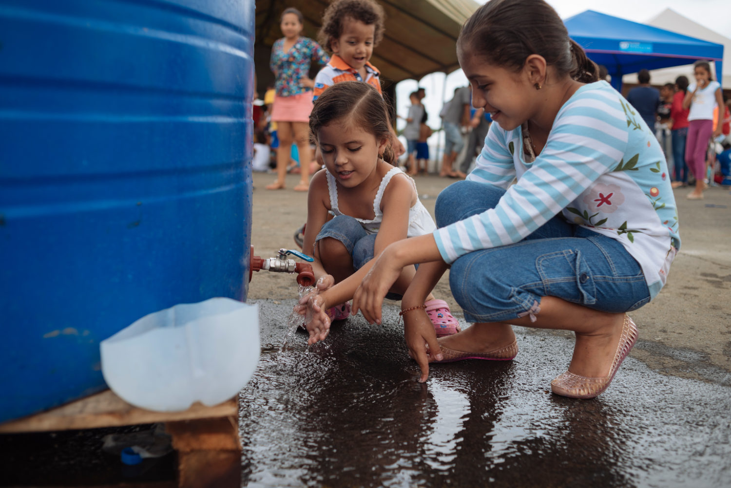 On 3 May 2016, girls wash their hands with running water at the shelter for earthquake-affected people in Portfoviejo, Manabi.