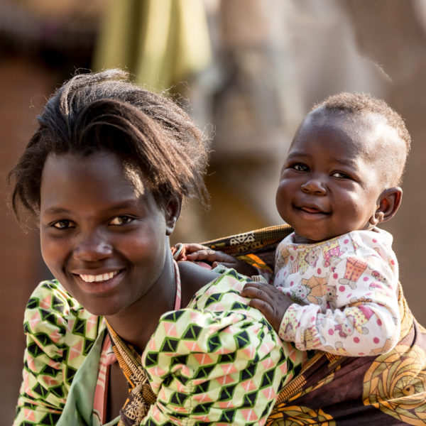 Leaving a gift in your Will can create a safer world for children. Martha, 19, carries her son Rahim, who is eight months old. Martha was born with HIV but has defied odds and her son is part of Malawi's AIDS-free generation. Photo: Unicef 2015 Schermbrucker