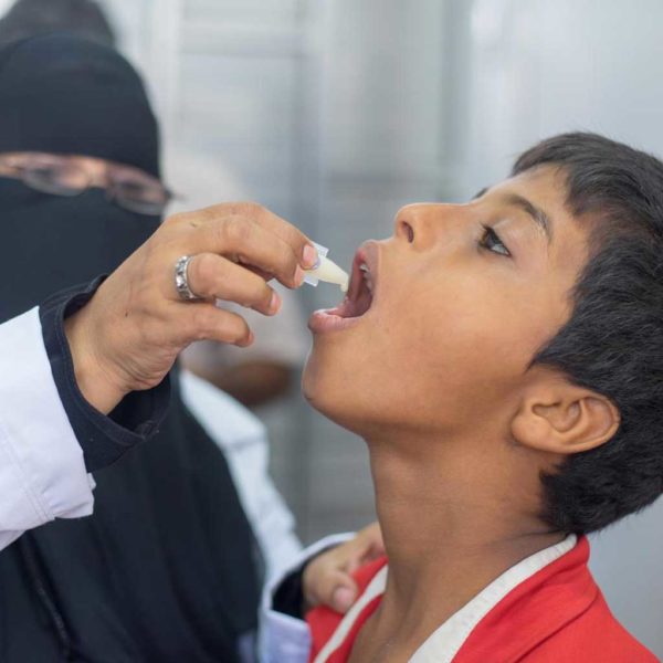 Emergency staff give a boy a cholera vaccine in Yemen