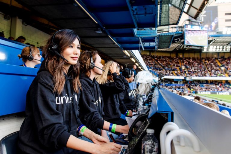 Gemma Chan takes calls from supporters at Soccer Aid for Unicef